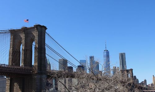 Low angle view of brooklyn bridge against clear blue sky