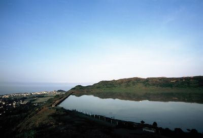 Calm countryside lake against mountain range