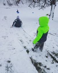 Rear view of boy on snow