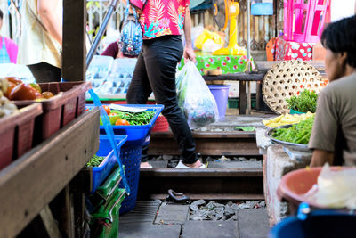 Low section of people standing at market stall