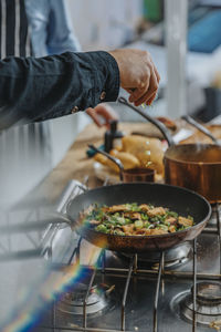 Midsection of man preparing food in kitchen