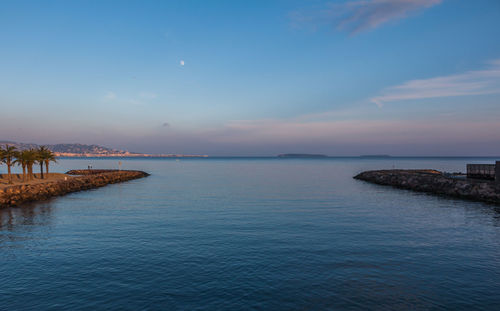 Scenic view of calm sea against cloudy sky