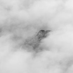 Island appearing from mist on derwent water in black and white