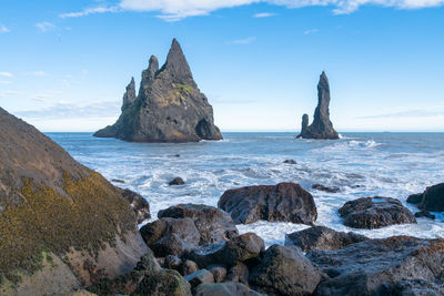 Waves hit the coast of the black beach in vik i myrdal, iceland.