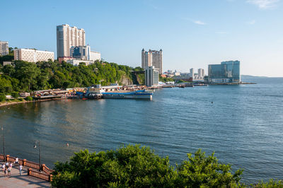 Scenic view of sea by buildings against sky