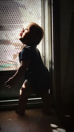 Boy sitting in window
