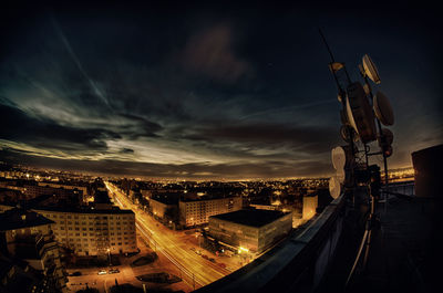 Illuminated cityscape against sky at night