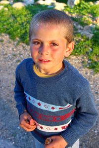 High angle portrait of cute boy standing on land