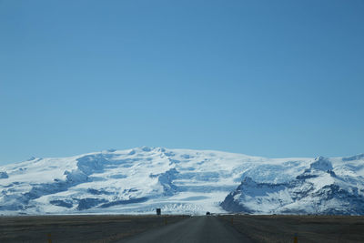 Scenic view of snow mountains against clear blue sky