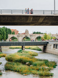 Bridge over river against trees