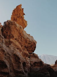 Low angle view of rock formation against sky