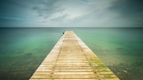 Pier over sea against sky
