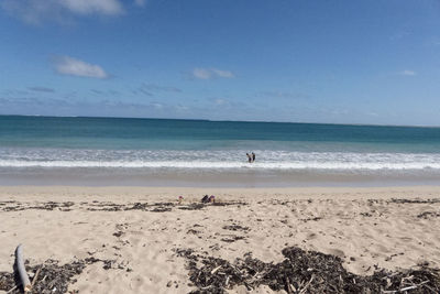 Scenic view of beach against blue sky