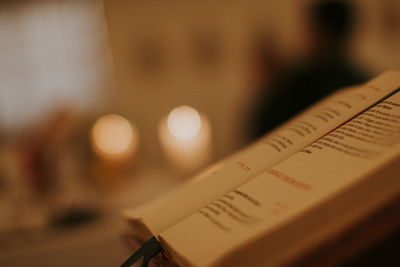 Close-up of text on book at table
