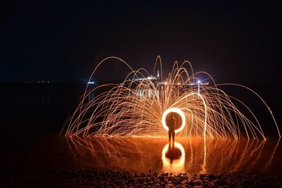 Person with wire wool on mountains at night