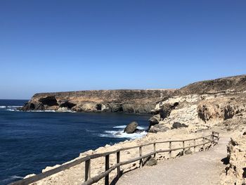 Scenic view of sea against clear blue sky