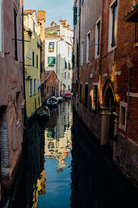 Boats in canal with buildings in background