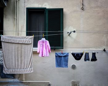 Rear view of clothes drying against building