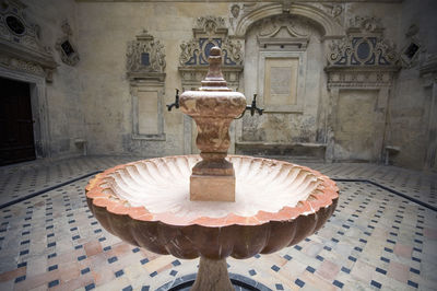 Close-up of fountain on table against building