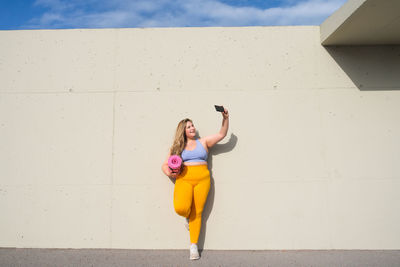 Young woman talking selfie through smart phone