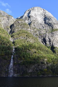 Scenic view of waterfall against sky