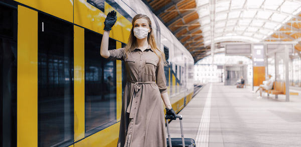 Woman standing on railroad station platform