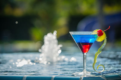 Drink in martini glass by fountain