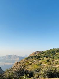 Scenic view of mountains against clear blue sky