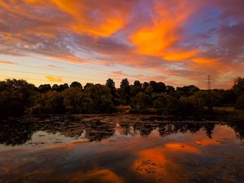 Scenic view of lake against orange sky