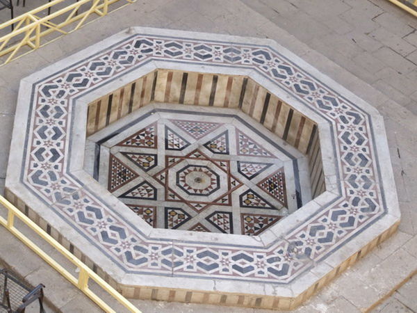 DIRECTLY BELOW SHOT OF ORNATE CEILING ON TILED FLOOR