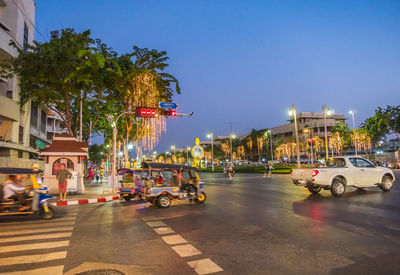 Cars on city street at night