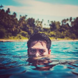 Close-up portrait of man swimming in pool