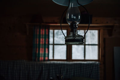 Low angle view of light bulb hanging on table at home