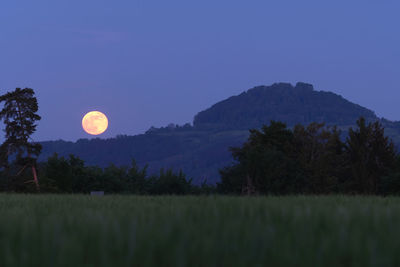 Scenic view of field against sky at night