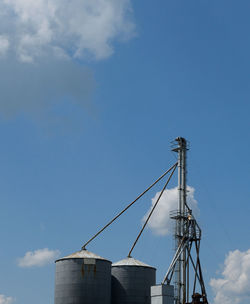 Low angle view of crane against sky