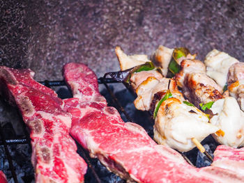 High angle view of meat on barbecue grill