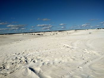 Scenic view of beach against blue sky