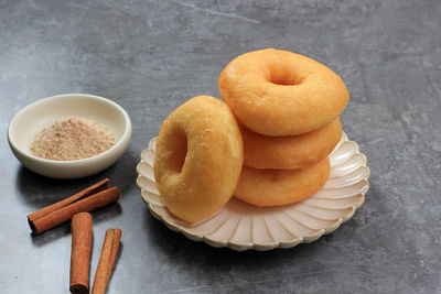 Stacked cinnamon donut, fresh fried donut with cinnamon sugar dusting. 