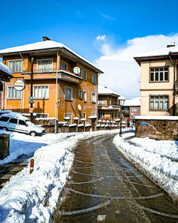 Street amidst buildings against sky