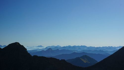 Scenic view of mountains against clear blue sky