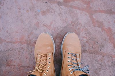 Low section of person standing on tiled floor