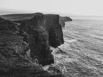 Rock formation on sea against sky