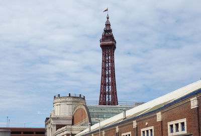 Low angle view of buildings against cloudy sky