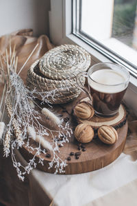 Still life cup coffee with cookies nuts on a wooden stand top view