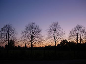 Silhouette bare trees against sky during sunset