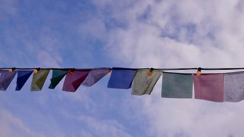 Low angle view of clothes drying on clothesline against sky
