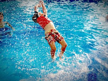 High angle view of boy jumping in pool