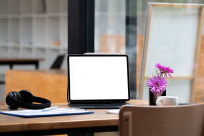 Flower vase on table at home