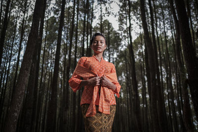 Portrait of a smiling young woman in forest