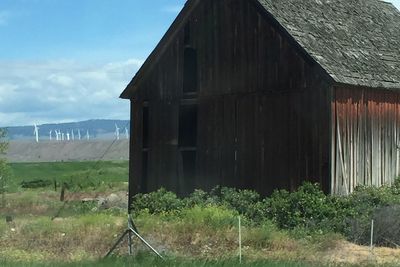 Built structure on field against cloudy sky